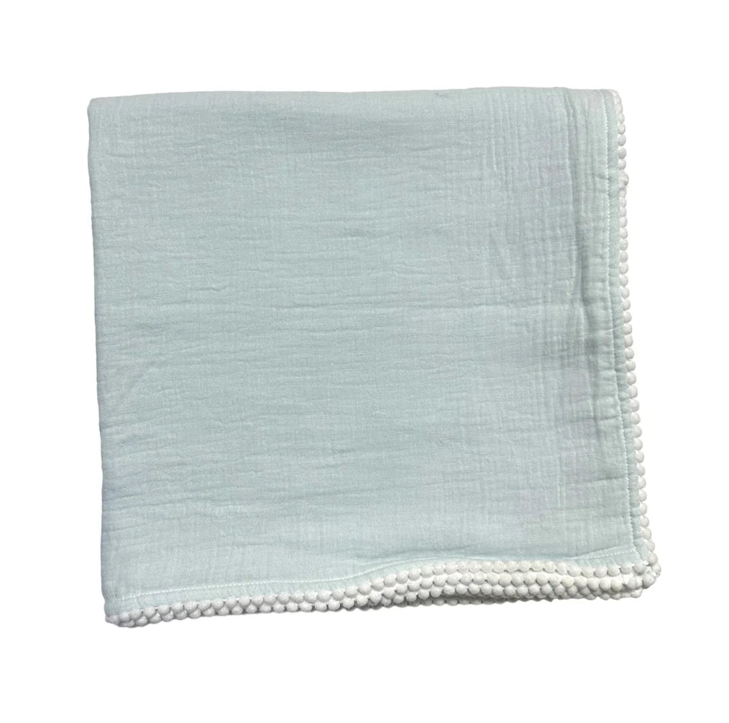 Soft light blue Cotton Muslin Swaddle Blanket- Blue featuring delicate textured fabric and a pom-pom trimmed edge, perfect for newborn essentials and baby gifts.