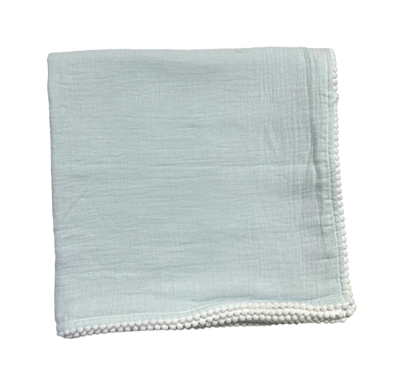Soft light blue Cotton Muslin Swaddle Blanket- Blue featuring delicate textured fabric and a pom-pom trimmed edge, perfect for newborn essentials and baby gifts.