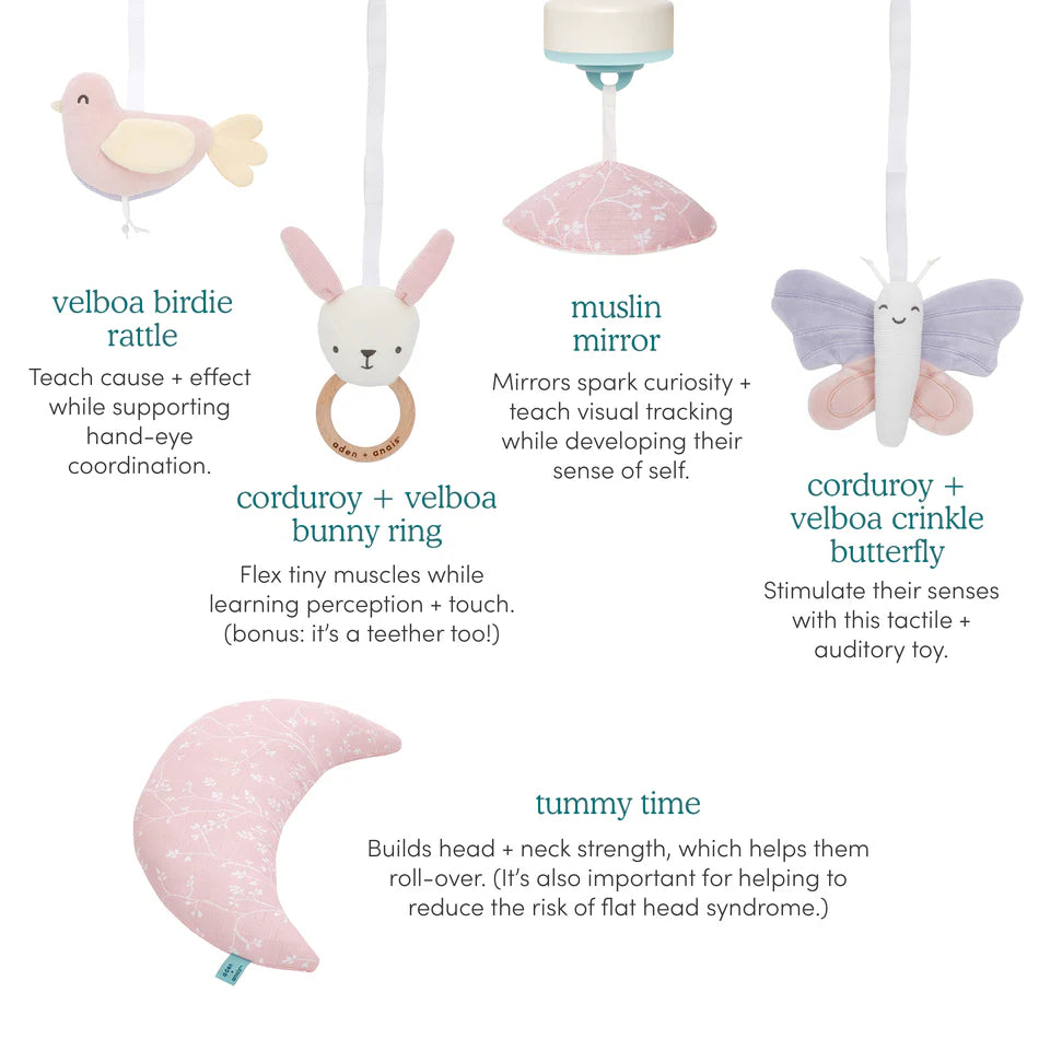 Ma Fleur Activity Gym featuring soft pastel toys including a velboa birdie rattle, corduroy and velboa bunny ring, muslin mirror, corduroy and velboa crinkle butterfly, and a tummy time cushion designed for sensory and motor skill development.