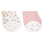 Earthly 2-pack Organic Burpy Bibs featuring a floral print in soft yellow and gray tones paired with a pink bib adorned with delicate leaves, both made from breathable organic muslin fabric.