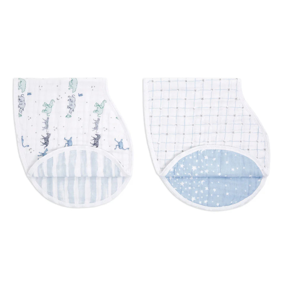 Two soft cotton muslin Rising Star 2-pack Classic Burpy Bibs with playful prints and pastel blue accents, designed for gentle baby feeding and burping.